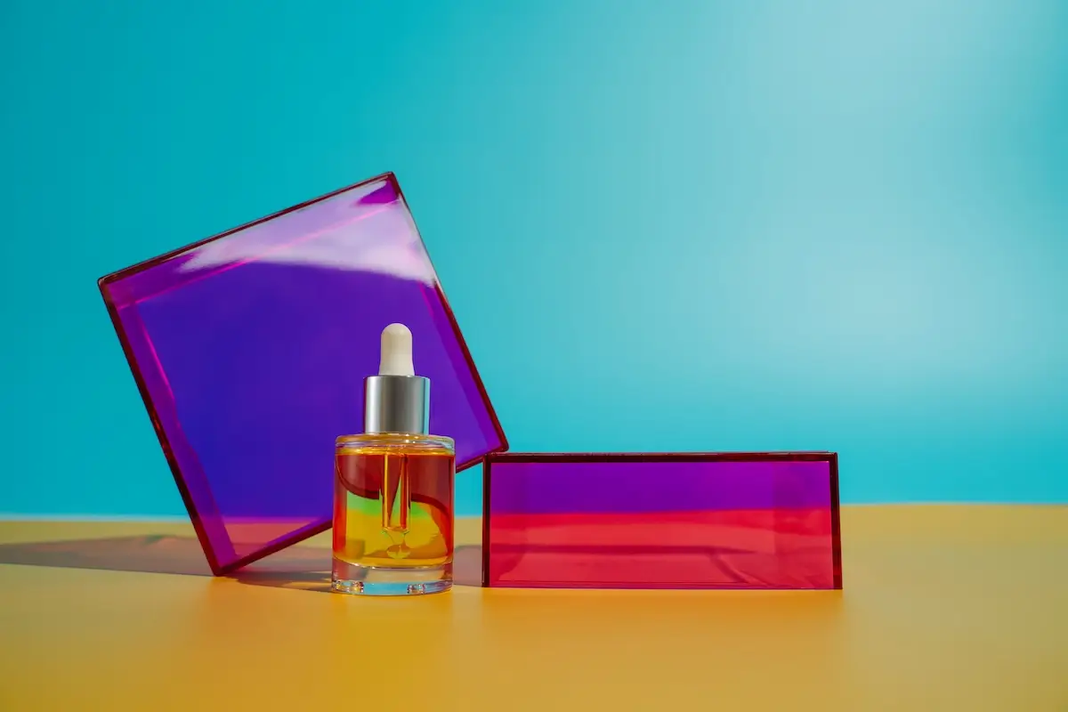 face oil in glass bottle on yellow and blue backgr 2025 02 12 03 19 56 utc