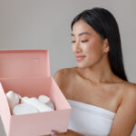 smiling young woman holding box with cosmetic prod 2025 03 24 20 39 29 utc