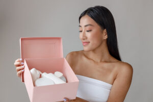 smiling young woman holding box with cosmetic prod 2025 03 24 20 39 29 utc