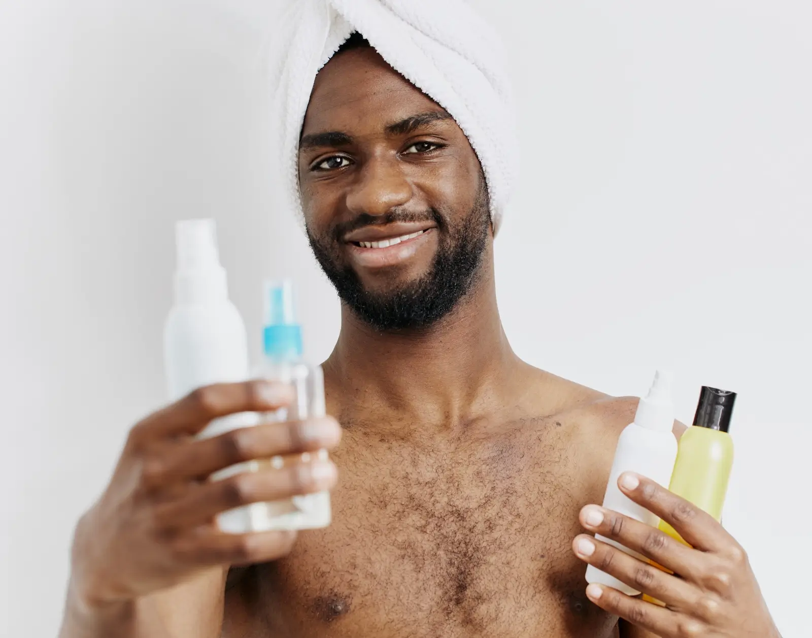 man in towel holding lotion bottles and covered he 2025 03 10 21 19 47 utc